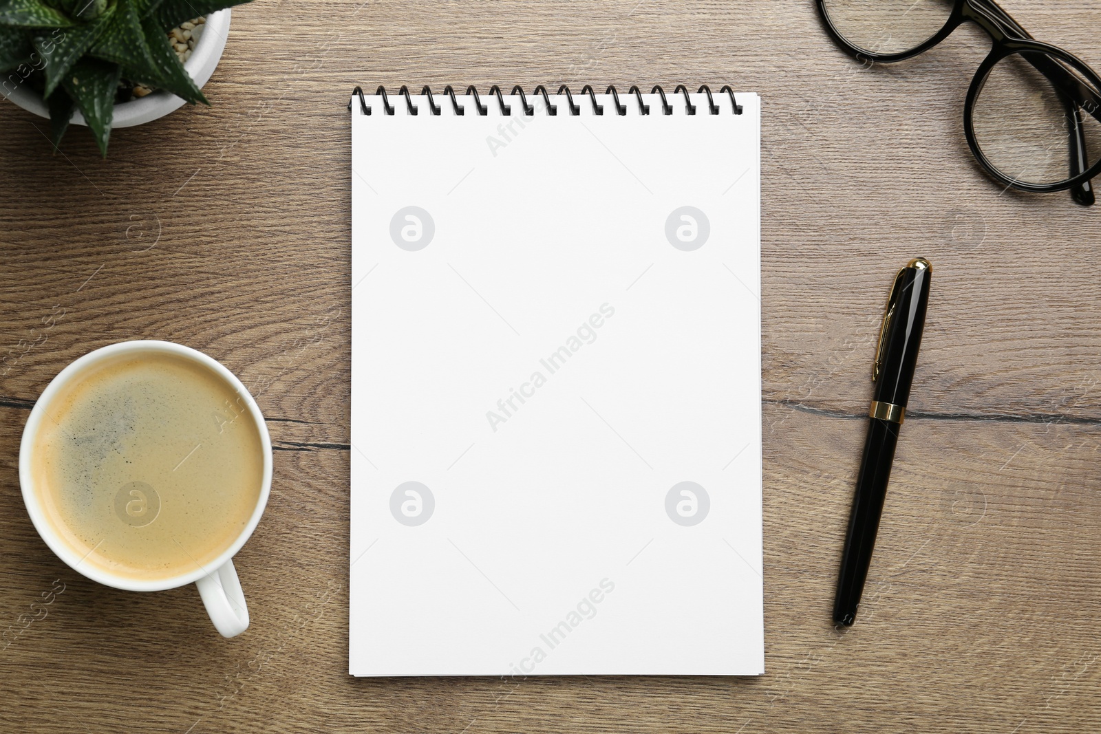 Photo of Flat lay composition with notebook on wooden table