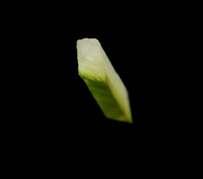 Photo of Piece of fresh cucumber on black background