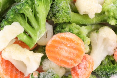 Photo of Mix of different frozen vegetables as background, top view