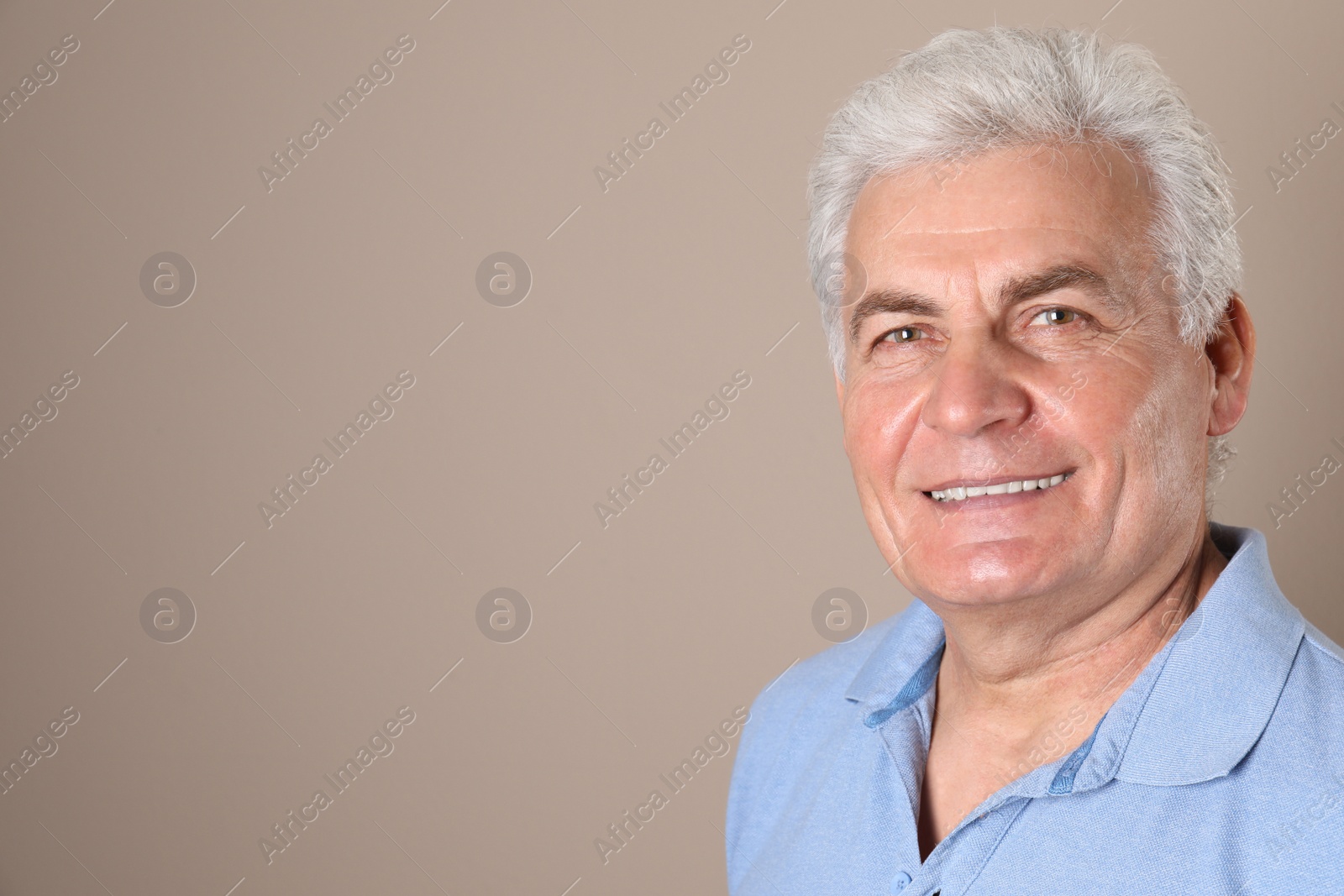 Photo of Mature man with healthy teeth on color background. Space for text