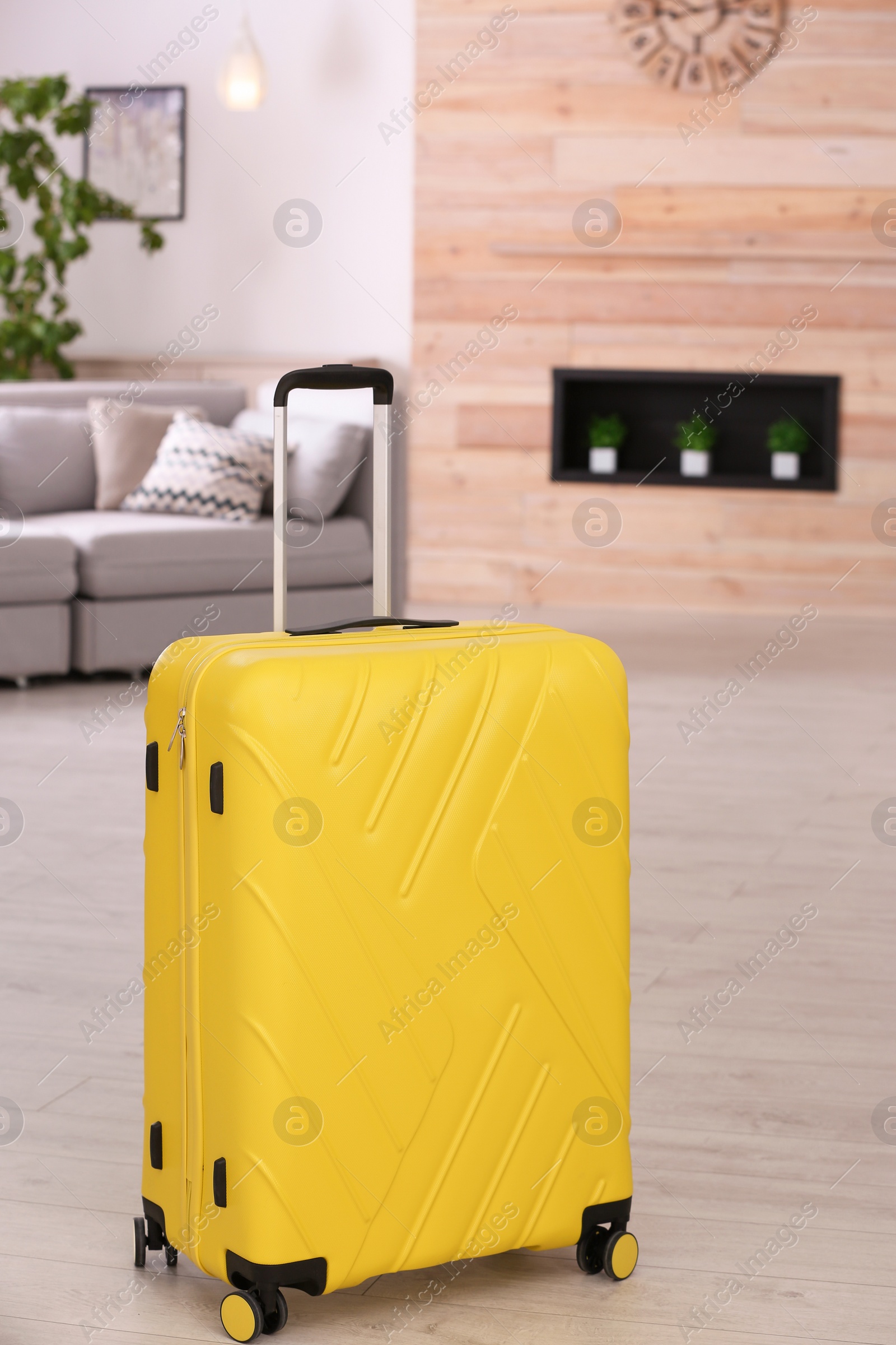 Photo of Colorful suitcase packed for journey in living room