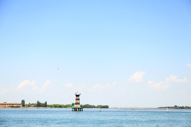 VENICE, ITALY - JUNE 13, 2019: Picturesque seascape with blue sky and coastline