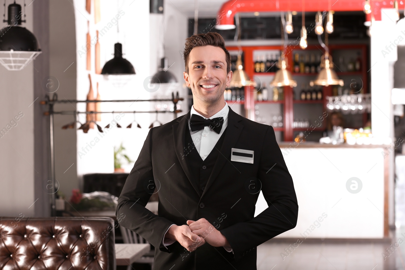 Photo of Waiter in elegant uniform at workplace