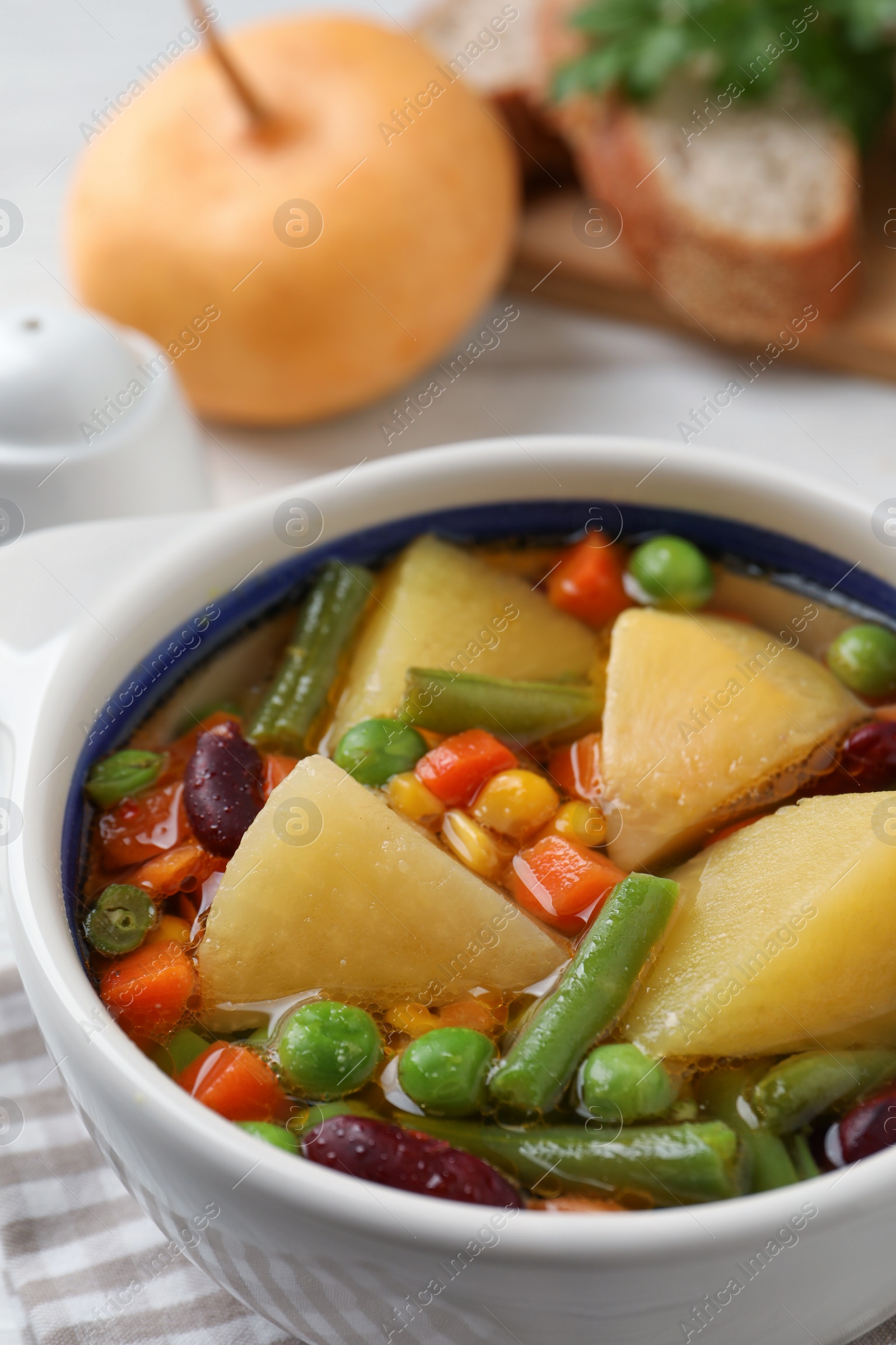 Photo of Bowl of delicious turnip soup on table, closeup view