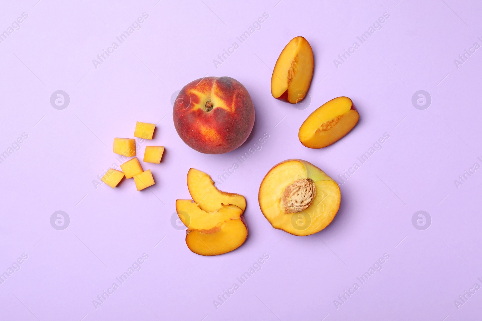 Photo of Flat lay composition with sweet juicy peaches on lilac background