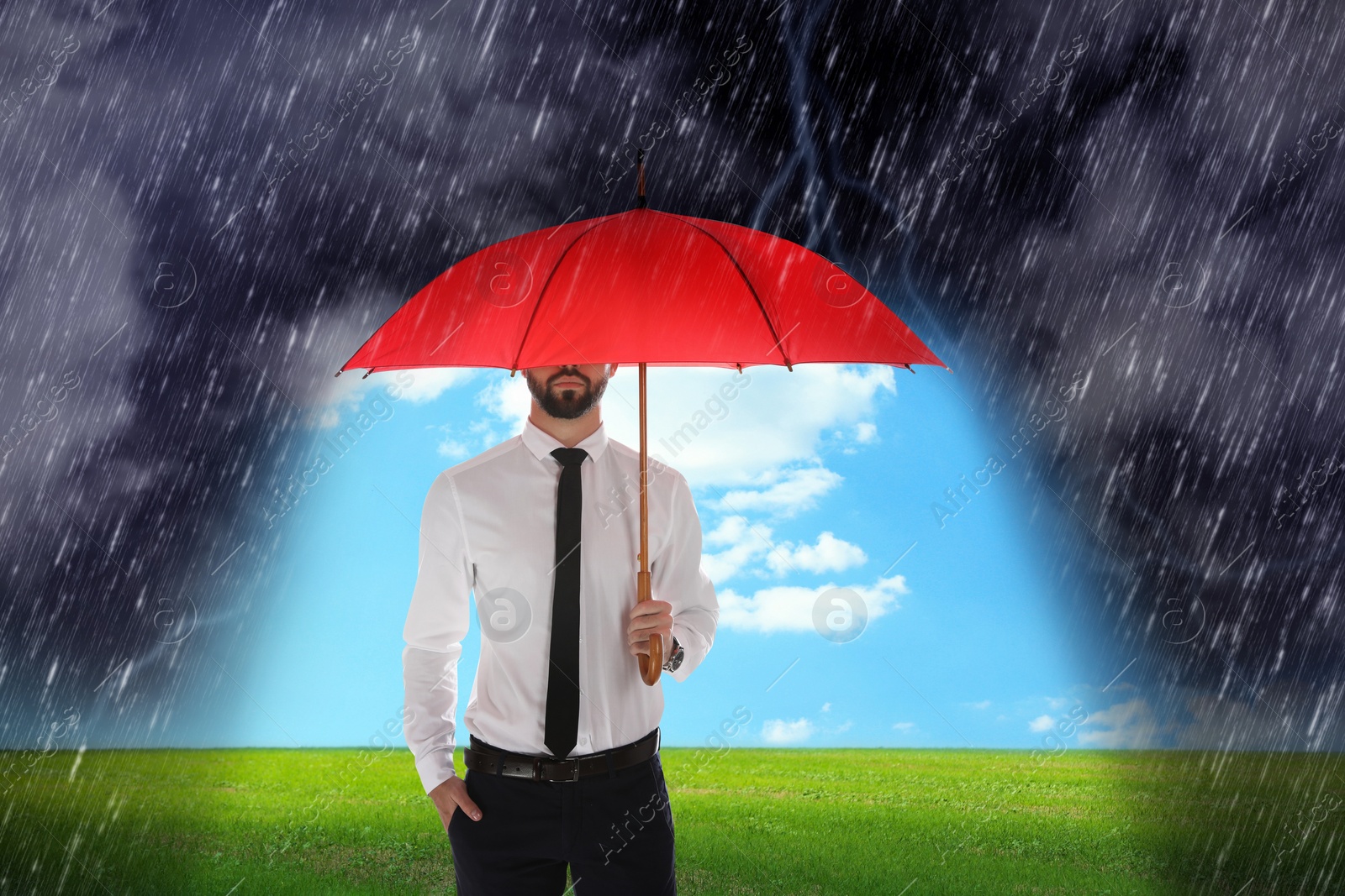 Image of Businessman with umbrella under heavy rain. Insurance concept