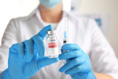 Doctor holding vial with vaccine against Covid-19, closeup