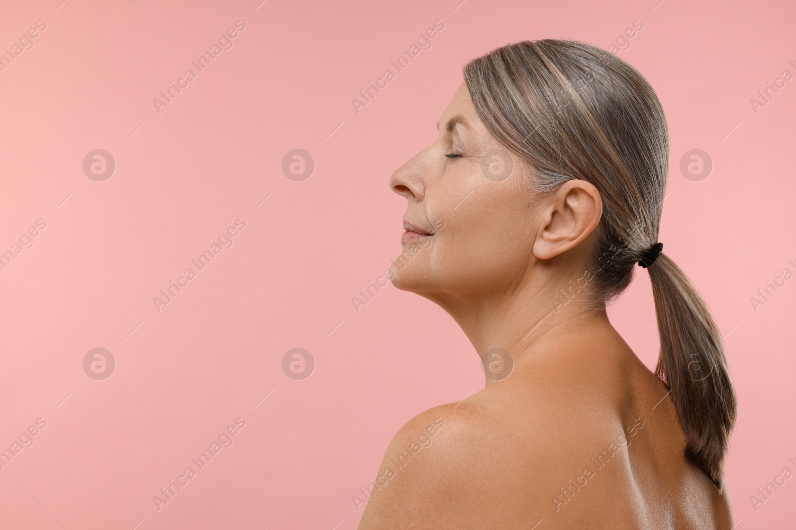 Photo of Beautiful woman with healthy skin on pink background, space for text