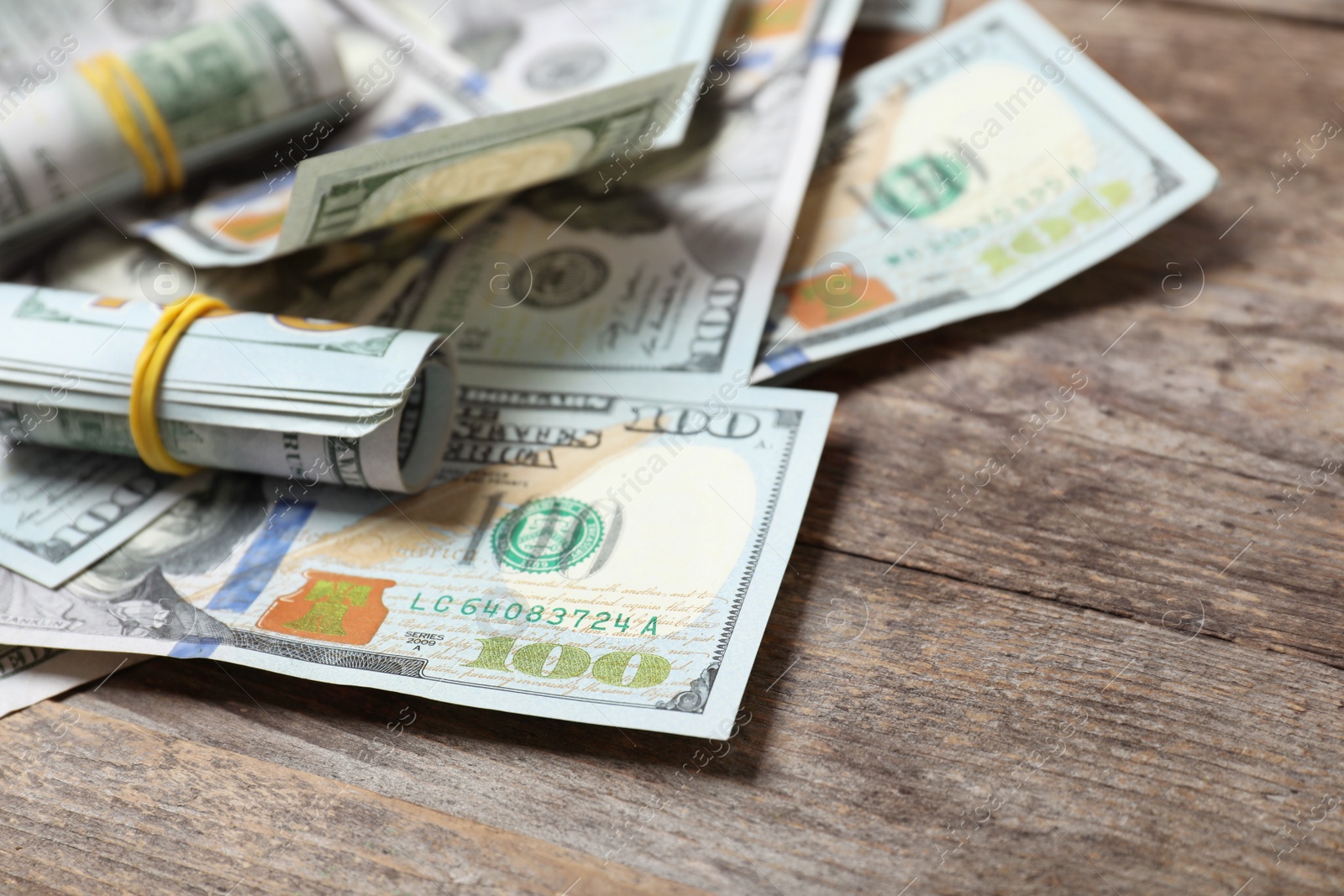 Photo of Many dollar banknotes on wooden table. National American currency