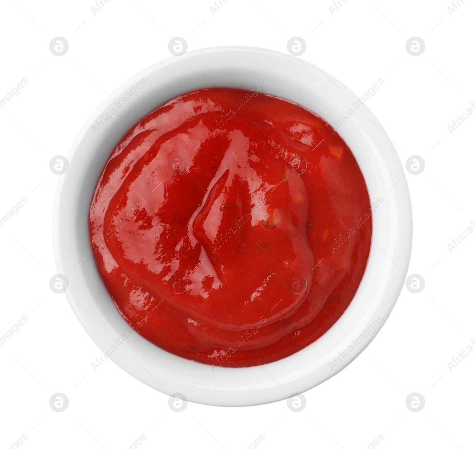 Photo of Bowl with red sauce isolated on white, top view