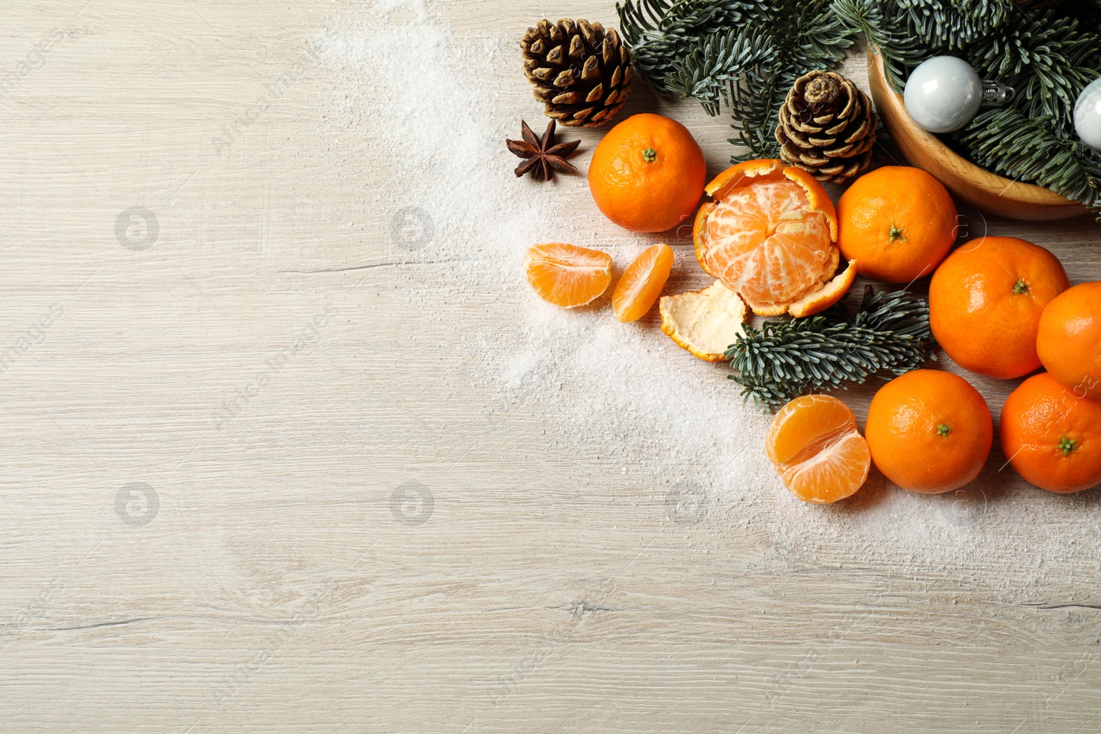 Photo of Flat lay Christmas composition with fresh tangerines on light wooden table. Space for text