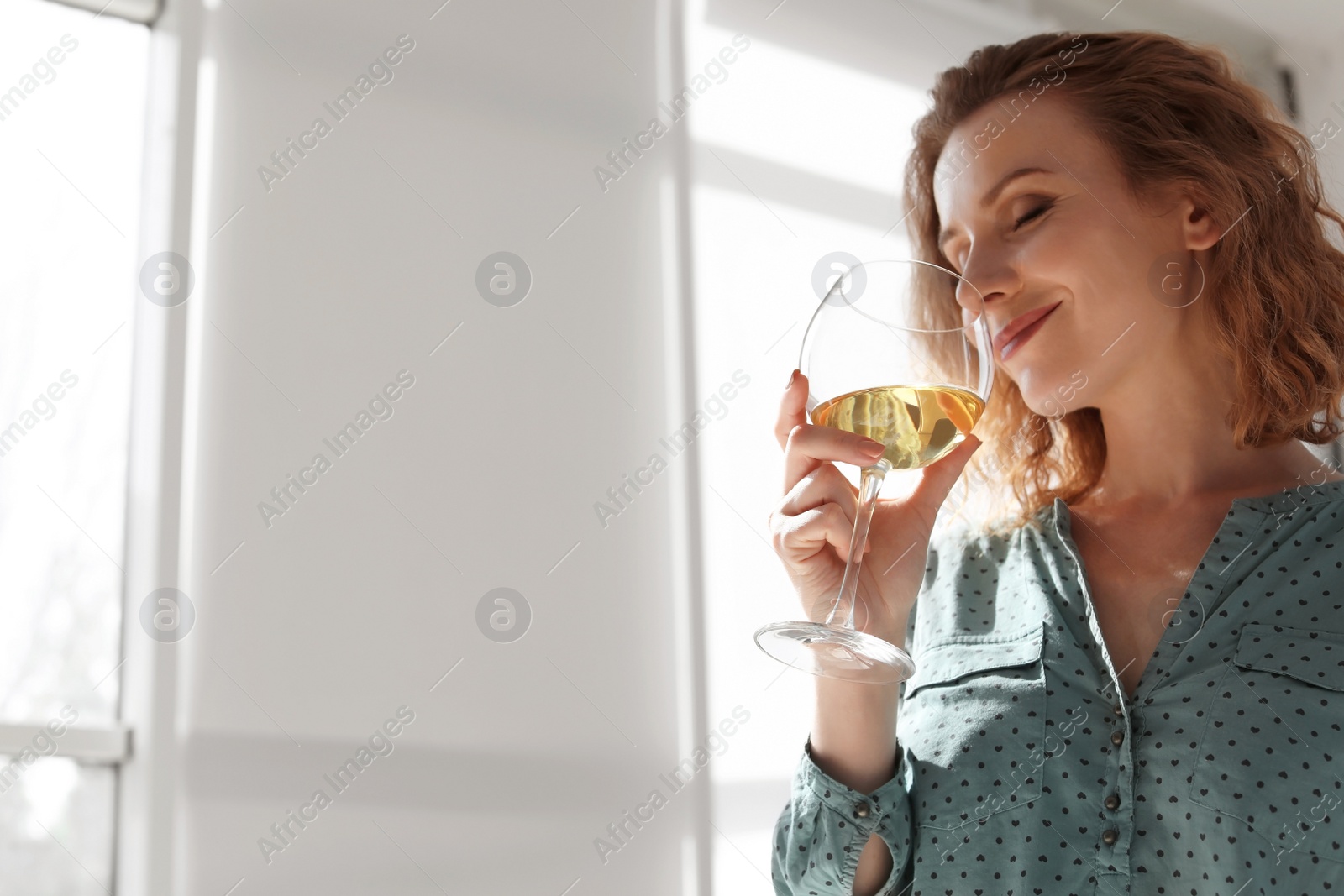 Photo of Woman with glass of delicious wine indoors