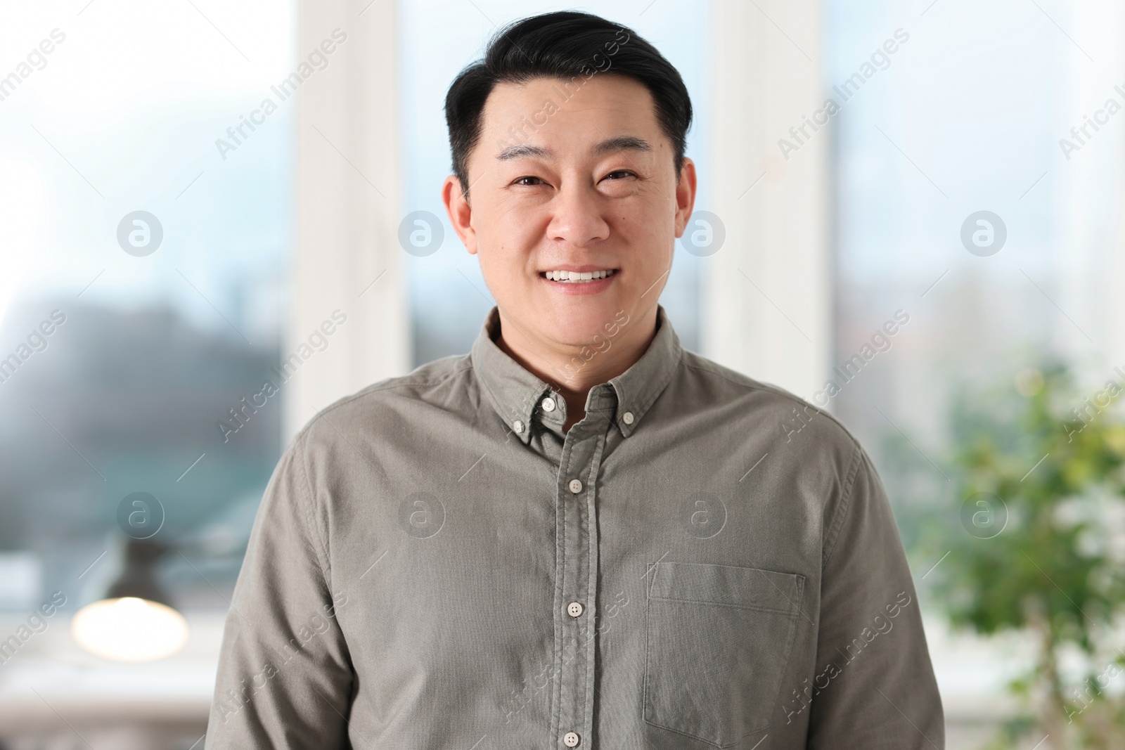 Photo of Portrait of smiling businessman in shirt indoors