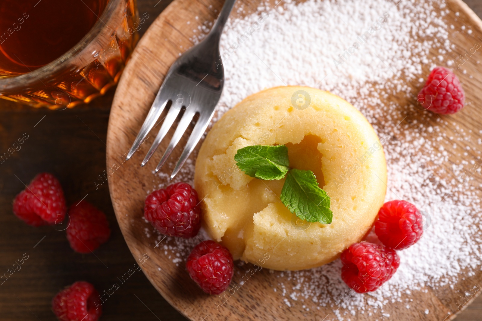 Photo of Tasty vanilla fondant with white chocolate and raspberries on table, flat lay