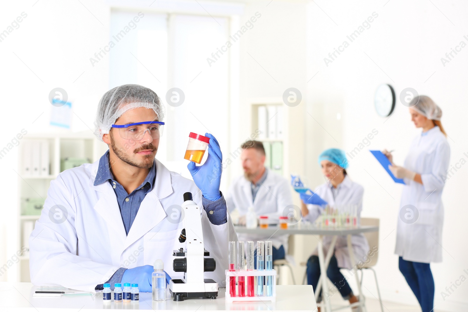 Photo of Male scientist working at table in laboratory, space for text. Research and analysis