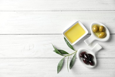 Photo of Flat lay composition with fresh olive oil on wooden background