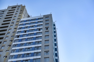 Unfinished building against blue sky. Space for text