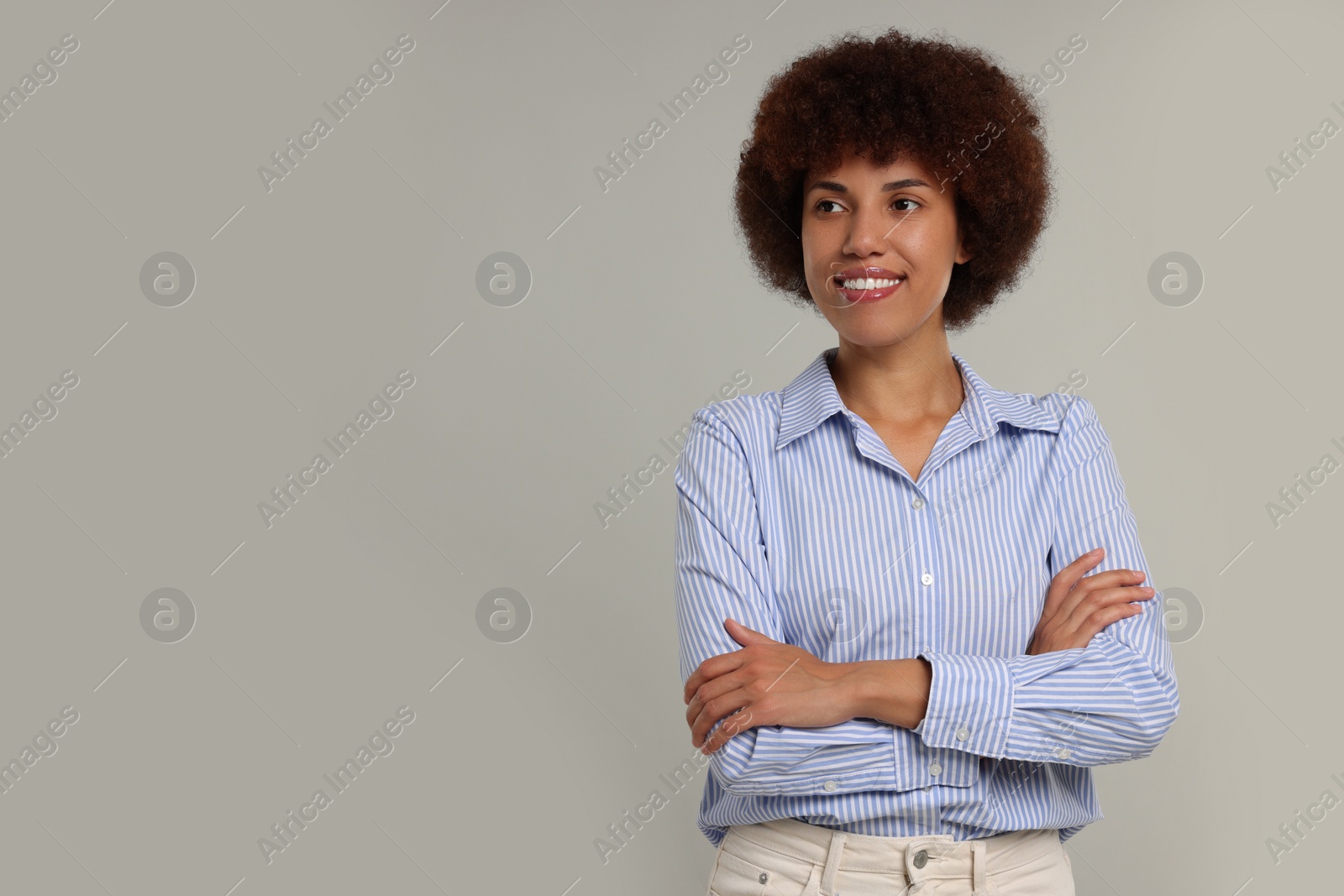 Photo of Portrait of happy young woman on grey background. Space for text