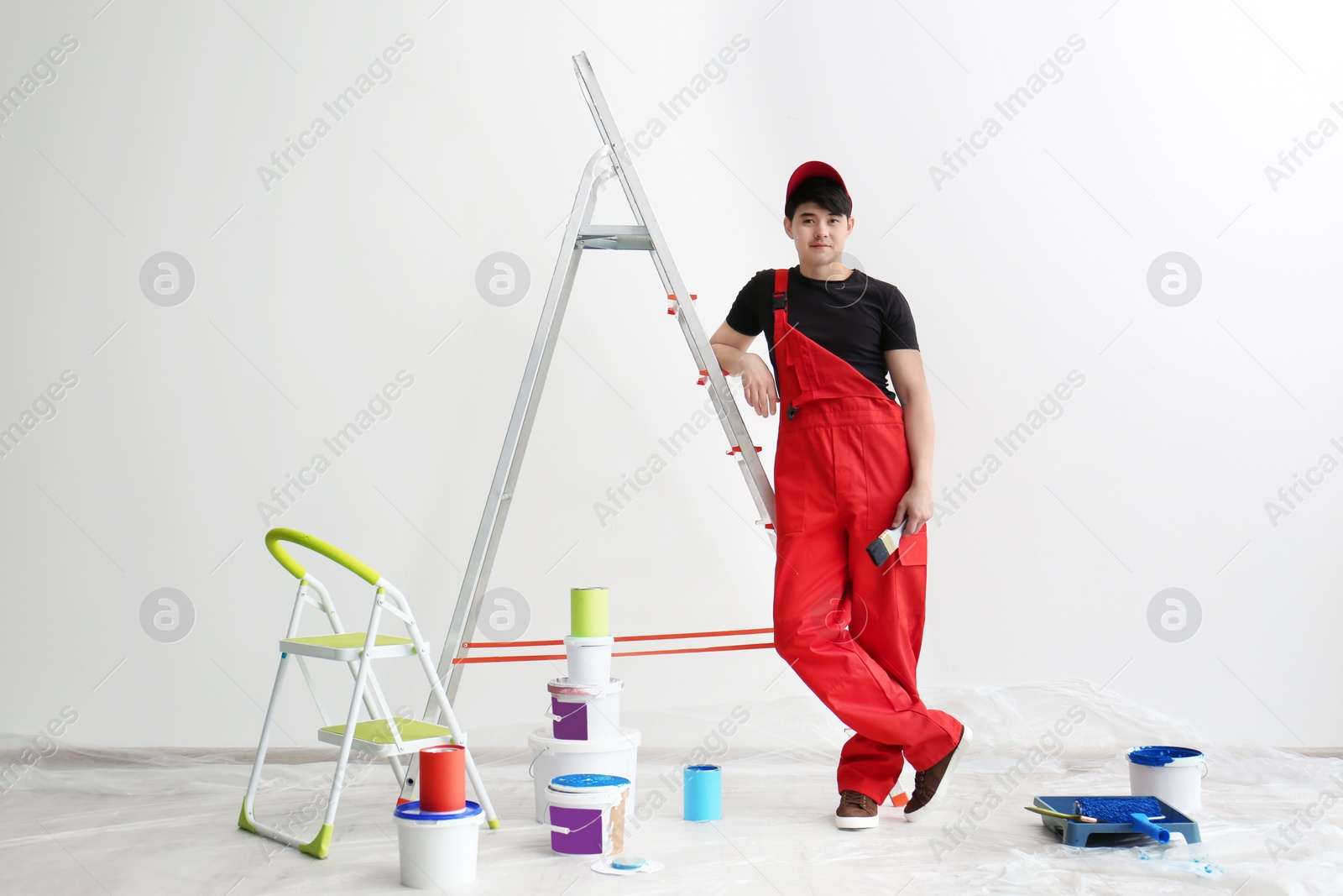 Photo of Portrait of male decorator in empty room