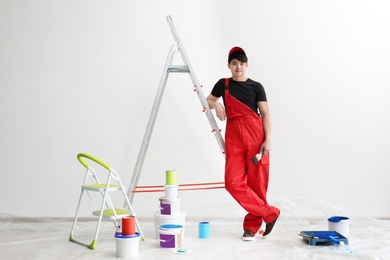 Photo of Portrait of male decorator in empty room