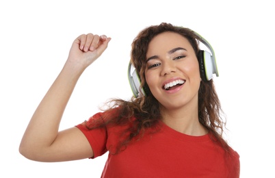 African-American girl listening to music with headphones on white background