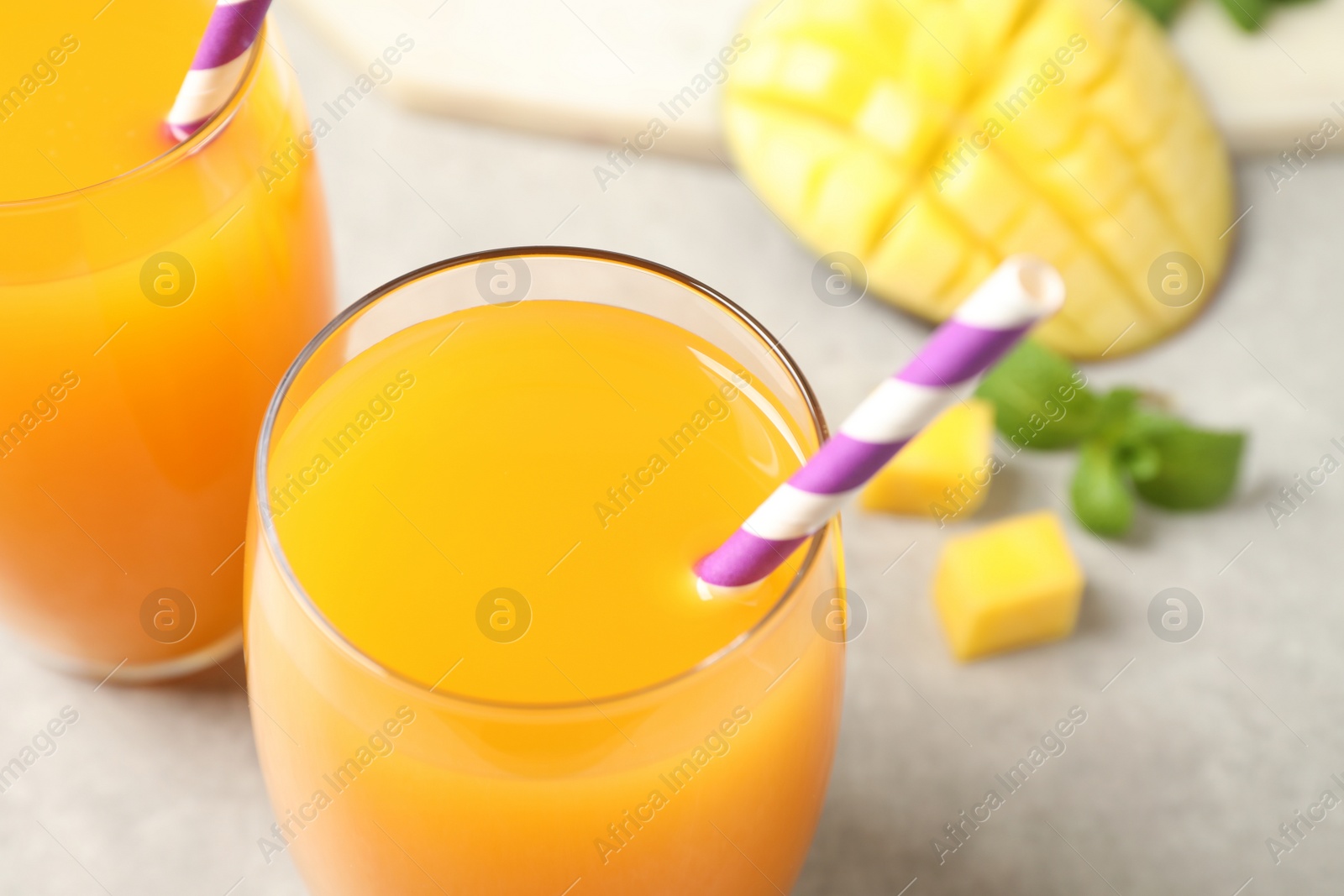 Photo of Fresh delicious mango drink on table, closeup