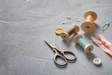 Set of tailoring accessories on grey background