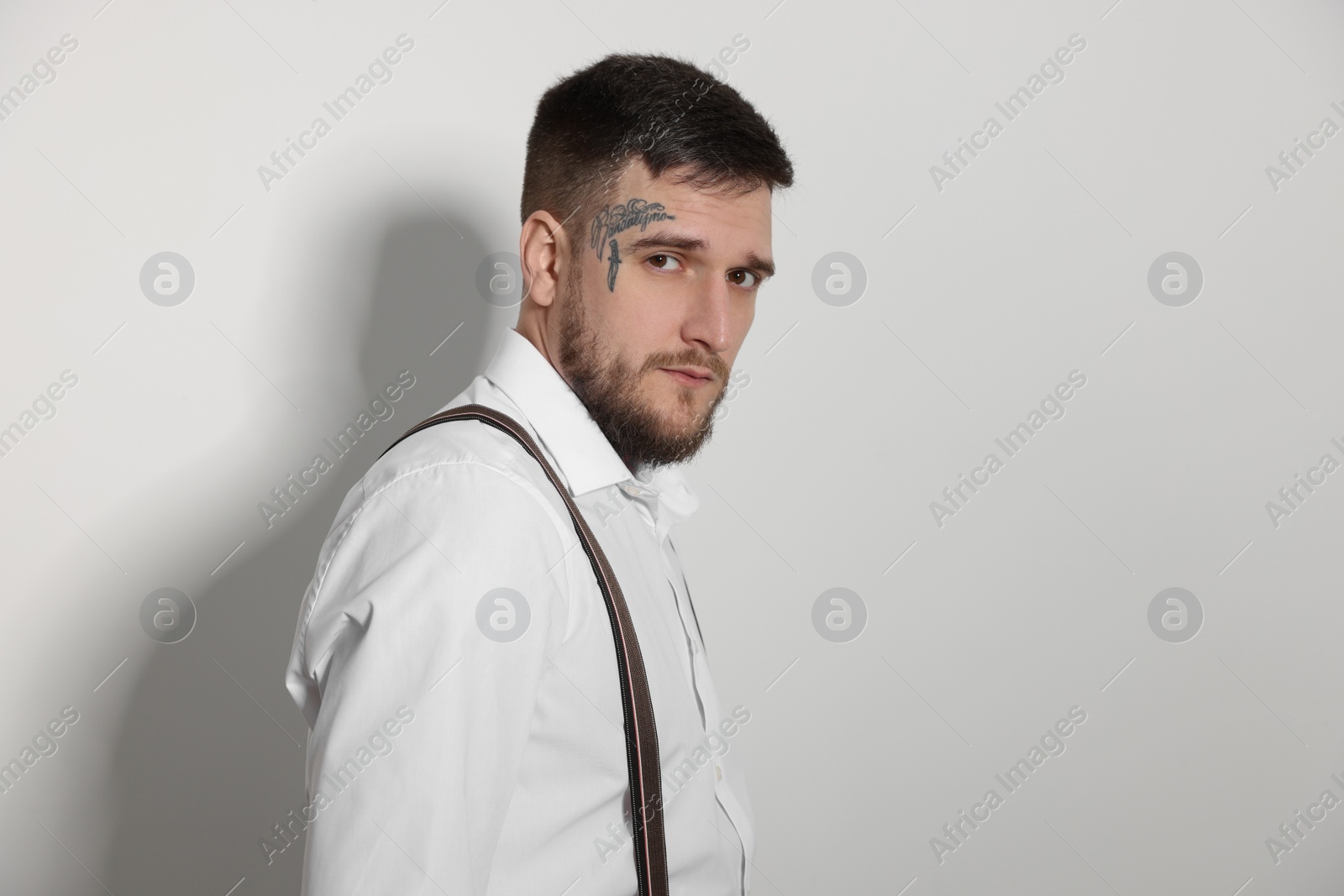 Photo of Portrait of handsome hipster man on light grey background. Space for text