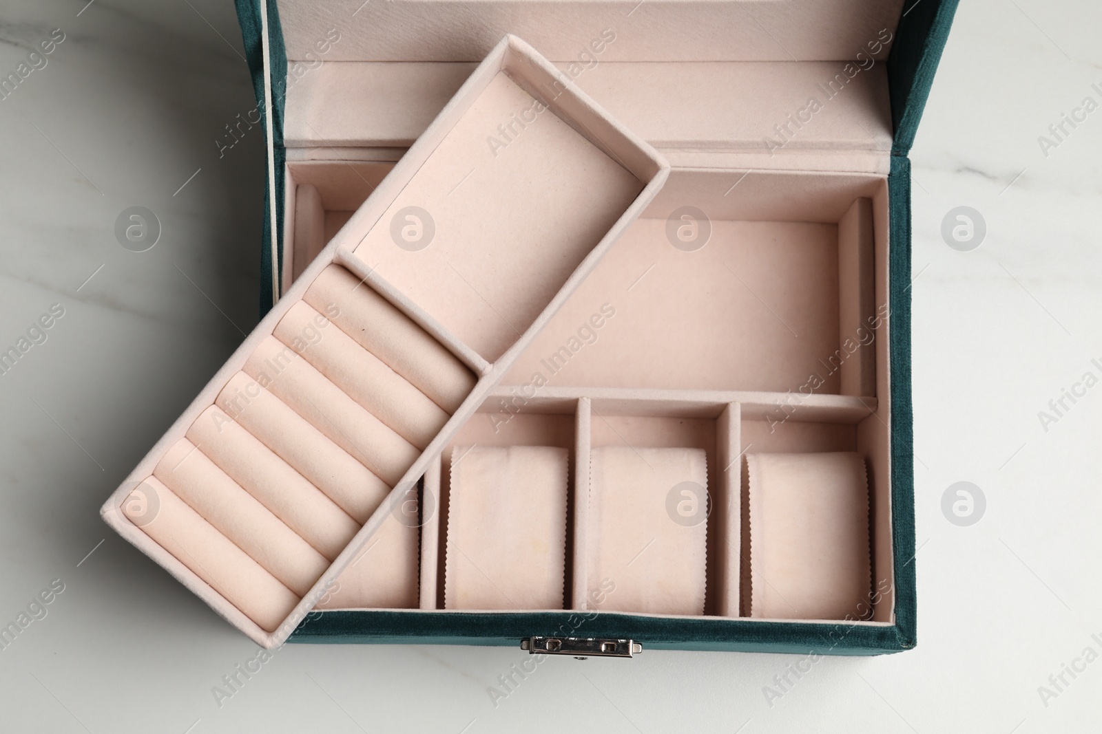 Photo of Empty beige jewelry box on white marble table, top view