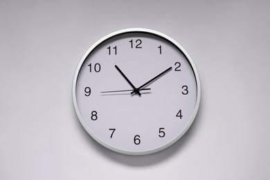 Photo of Stylish round clock on white background, top view. Interior element