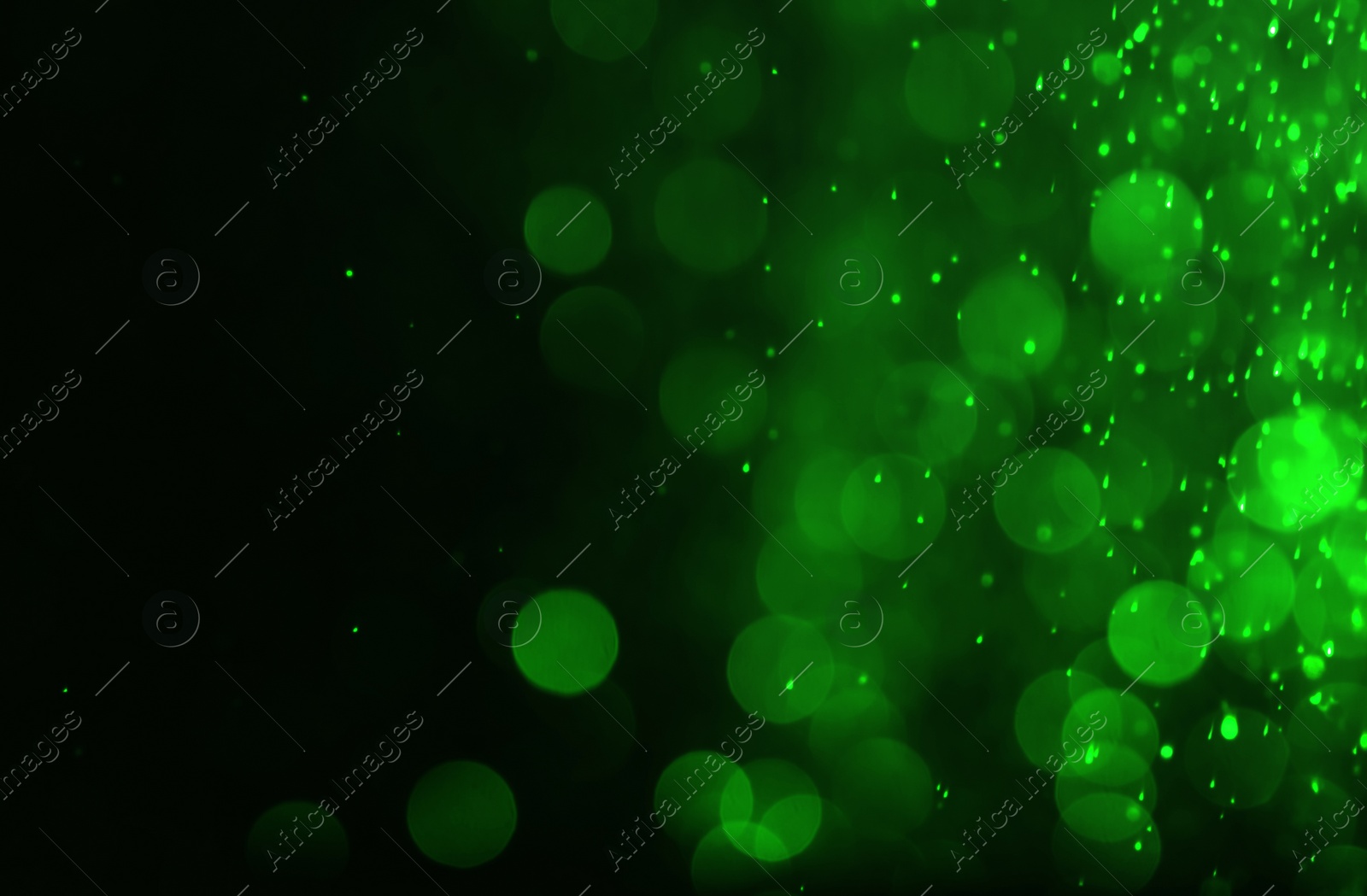 Image of St. Patrick day. Shiny green glitter on black background, bokeh effect