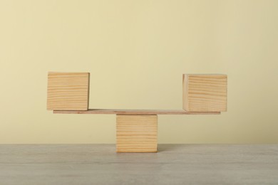 Photo of Plank with wooden cubes on table. Harmony and balance concept
