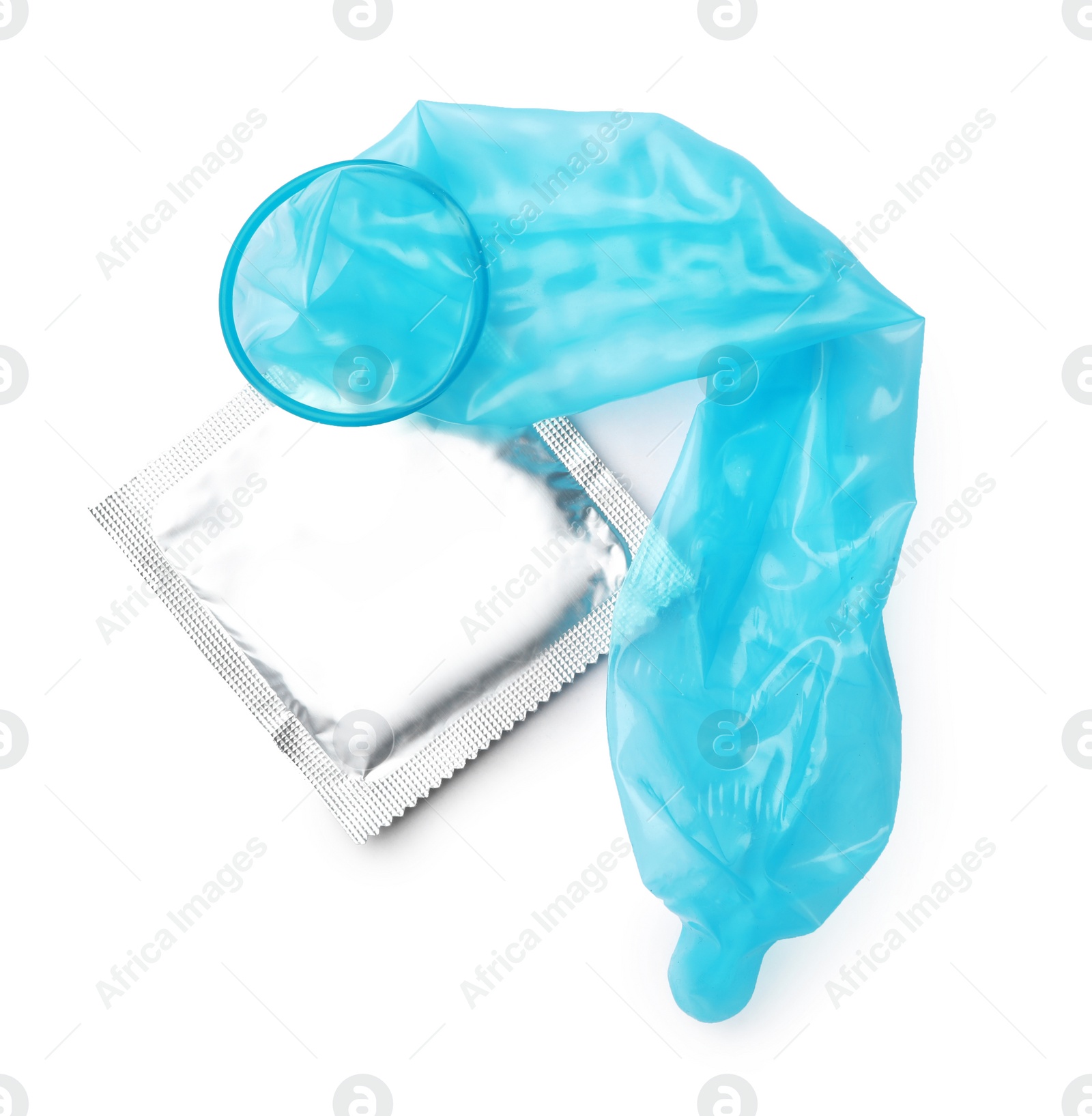 Image of Unrolled light blue condom and package on white background, top view. Safe sex