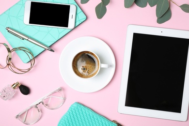 Photo of Flat lay composition with tablet, coffee and blogger's stuff on pink background