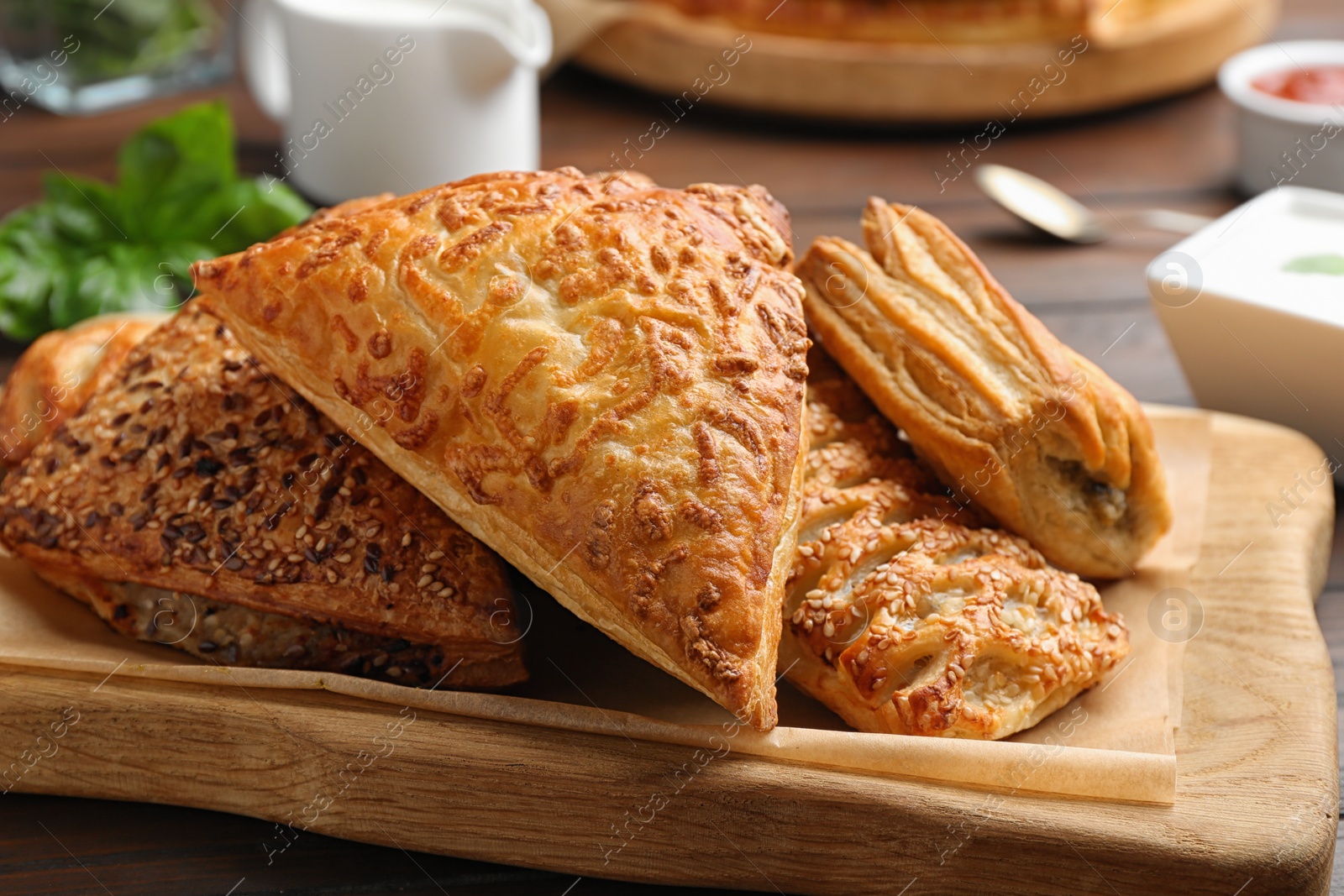 Photo of Fresh delicious puff pastry served on wooden table