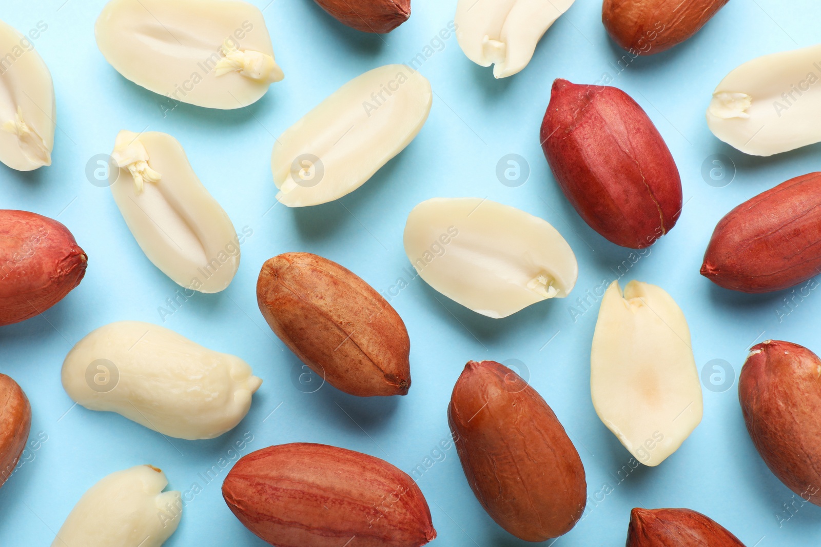 Photo of Fresh peanuts on light blue background, flat lay