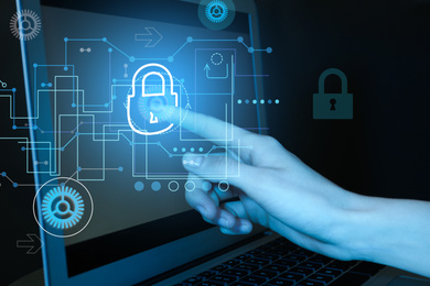 Image of Cyber attack protection. Woman touching lock icon on laptop screen, closeup