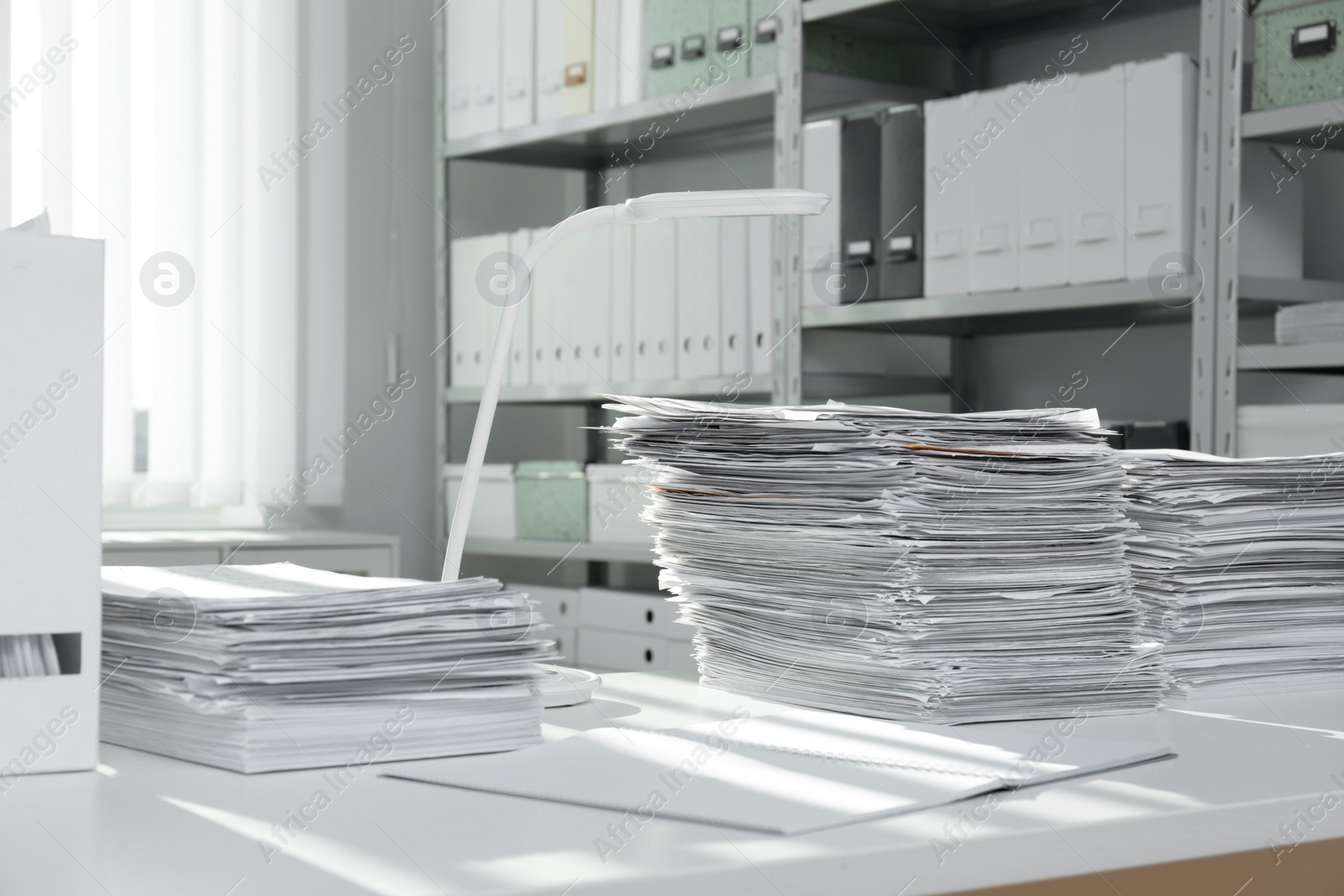 Photo of Stacks of documents on table in office