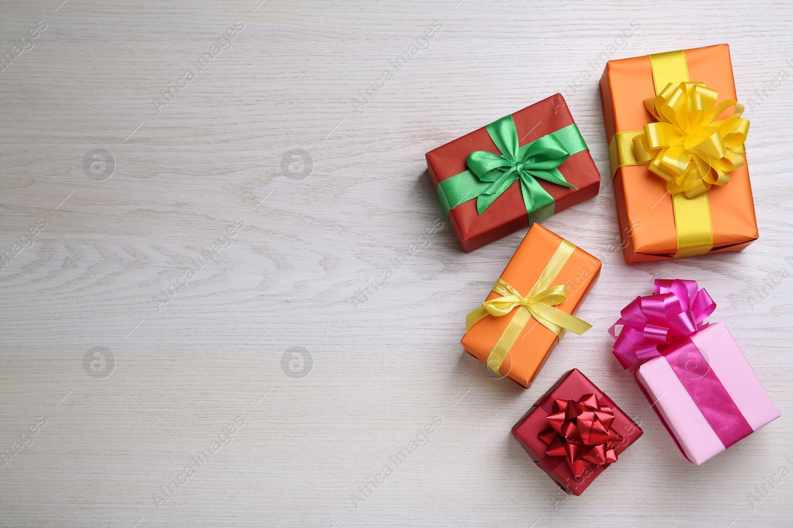 Photo of Many colorful gift boxes on white wooden table, flat lay. Space for text