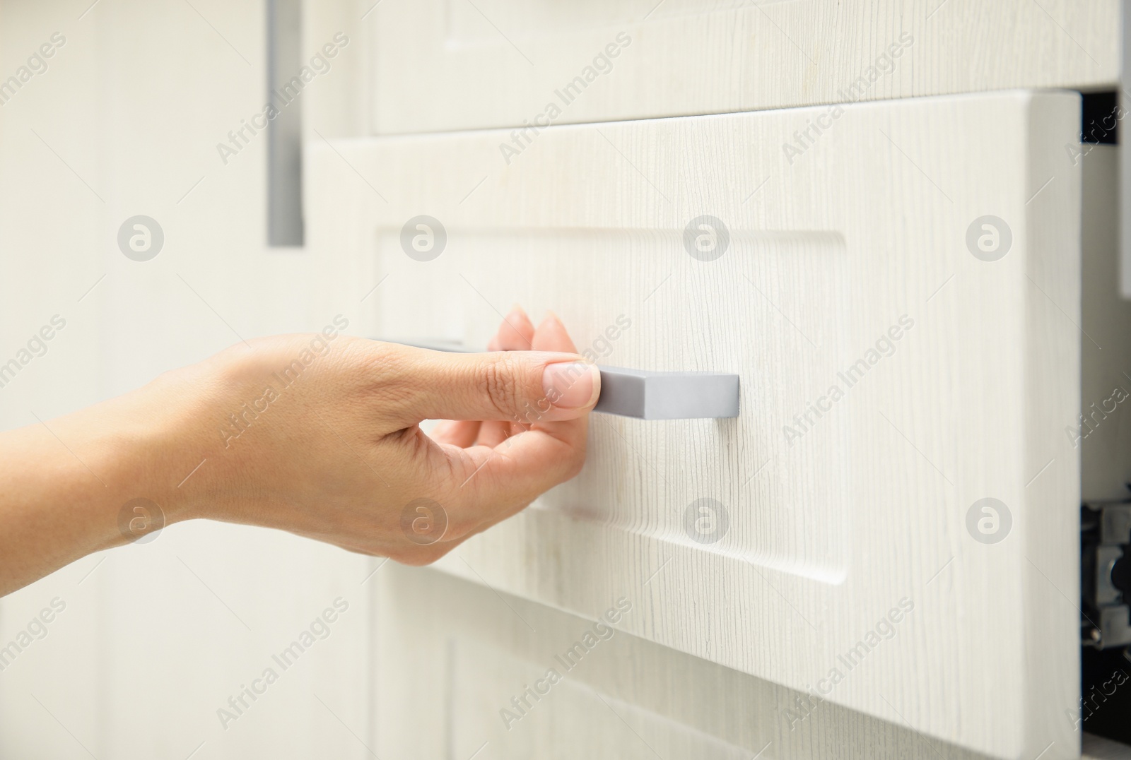 Photo of Woman opening drawer at home, closeup view