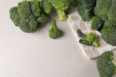 Photo of Fresh raw broccoli on white table, flat lay. Space for text