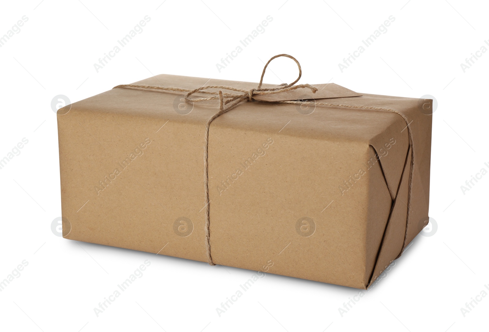 Photo of Parcel wrapped with kraft paper, twine and tag isolated on white