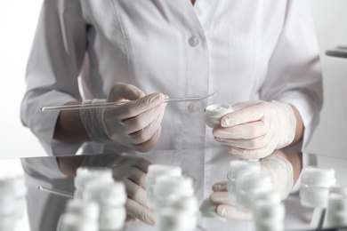 Photo of Scientist developing cosmetic product in laboratory, closeup