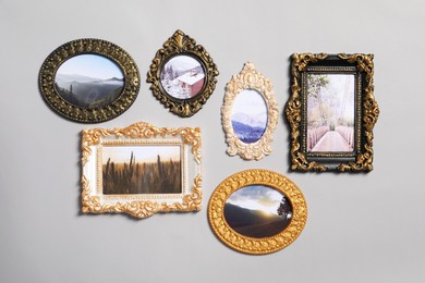 Photo of Vintage frames with beautiful photos of landscapes hanging on light gray wall