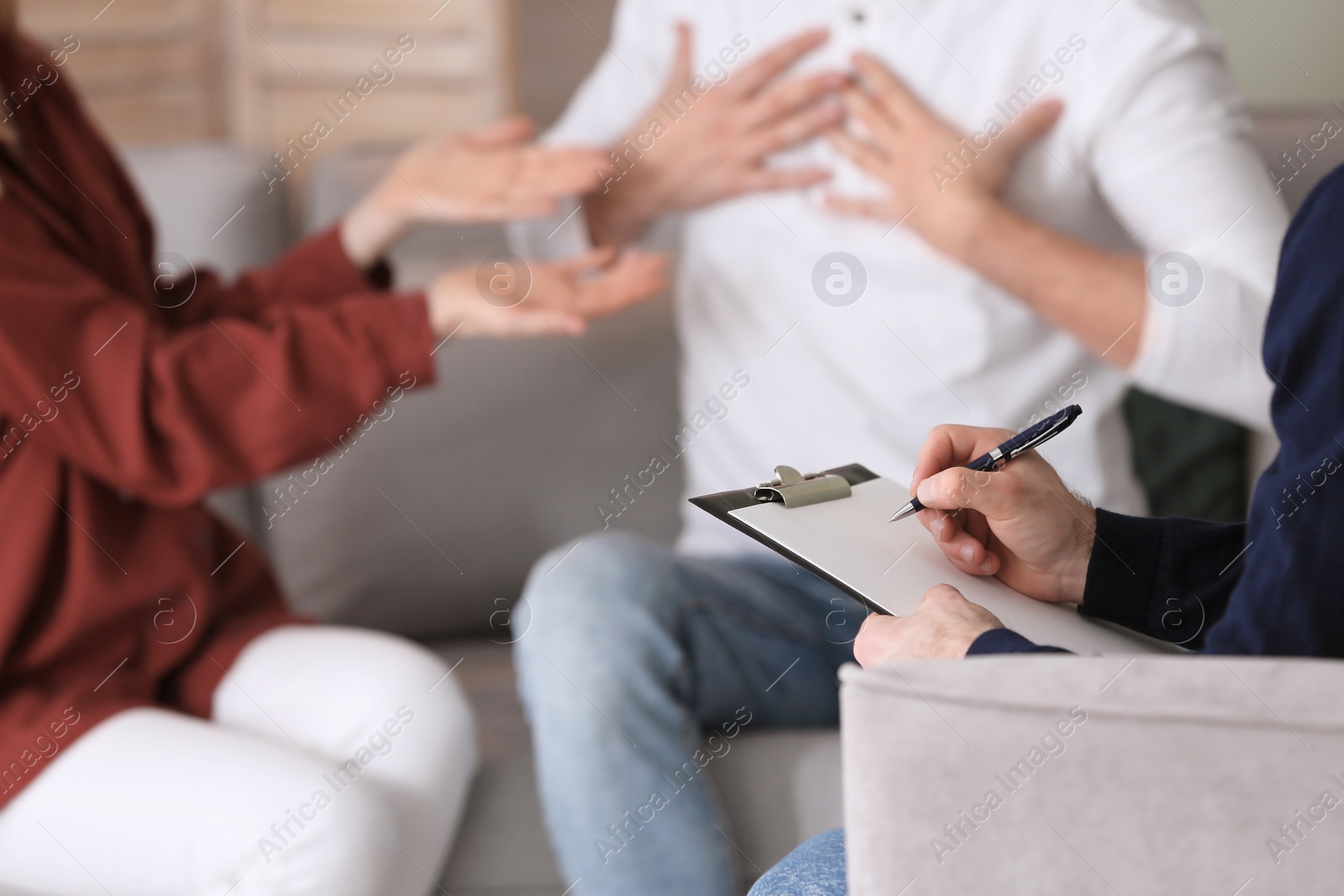 Photo of Family psychologist working with young couple in office, closeup