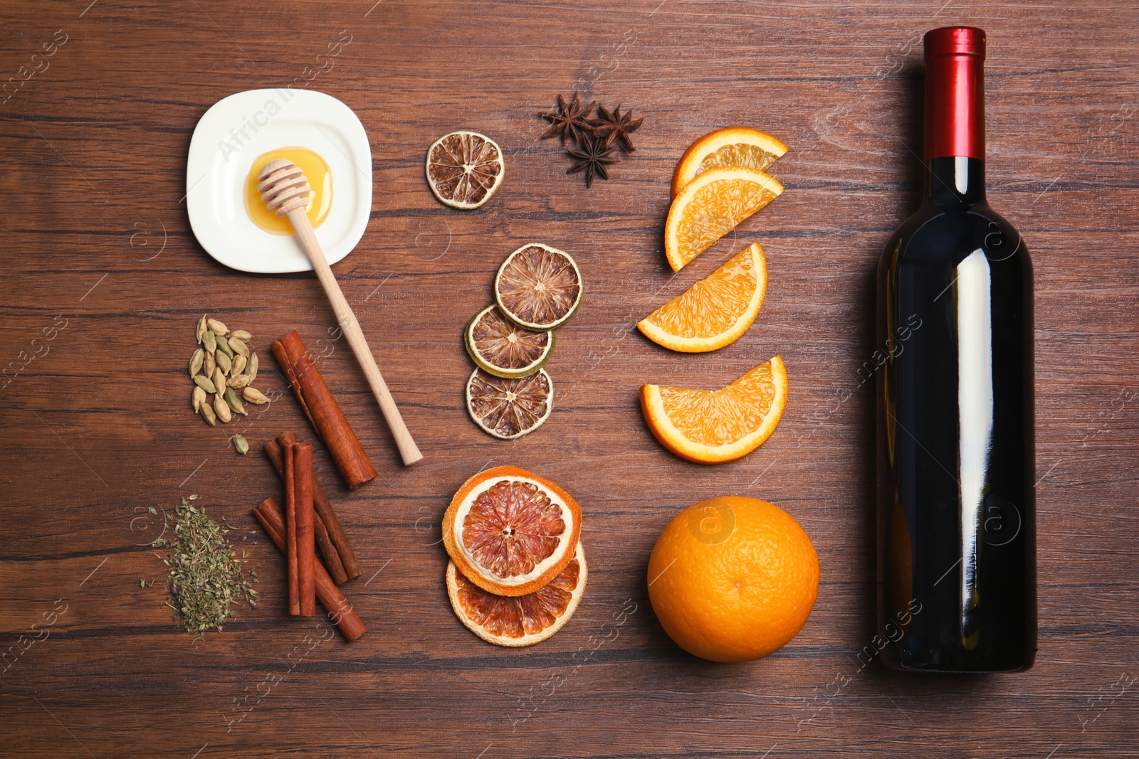 Photo of Flat lay composition with ingredients for mulled wine on wooden background