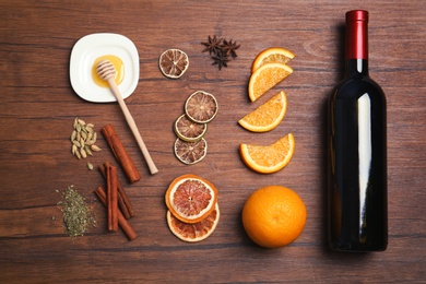 Photo of Flat lay composition with ingredients for mulled wine on wooden background