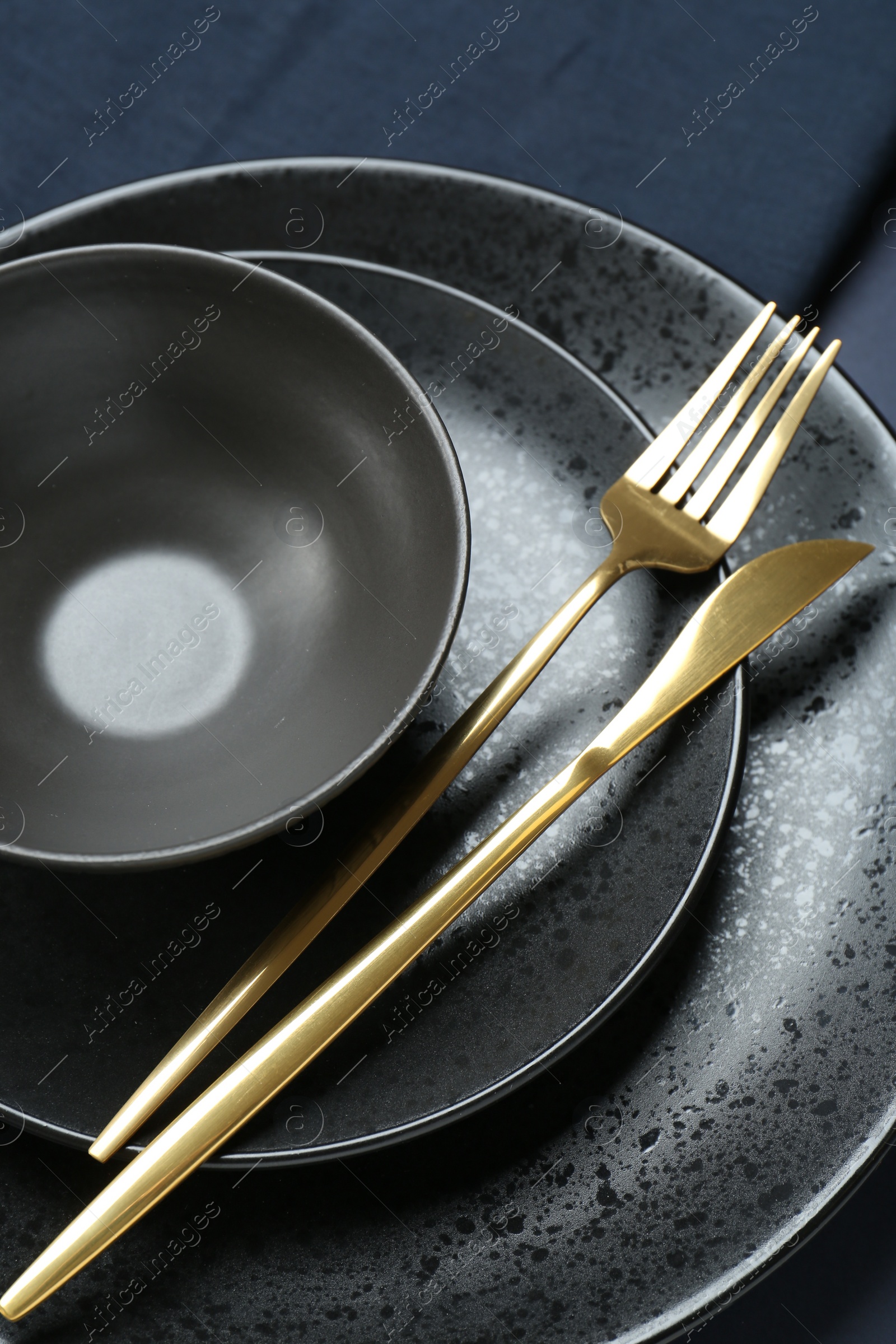 Photo of Stylish ceramic plates, bowl and cutlery on table, above view