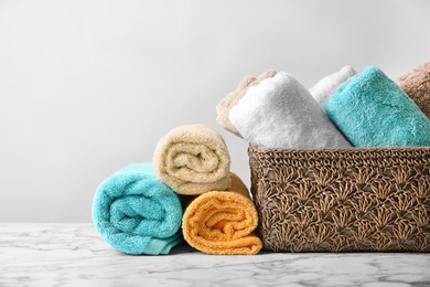 Photo of Clean towels on table against light background