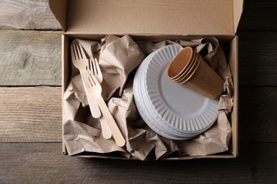 Photo of Box of waste paper on wooden table, top view